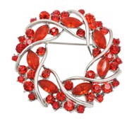 Broche - sølv cirkel med et væld af røde glitrende sten 